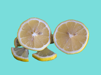 Close-up of oranges on table against blue background