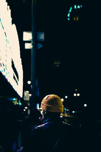 Man in illuminated city at night