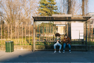 Man and woman with dog against trees