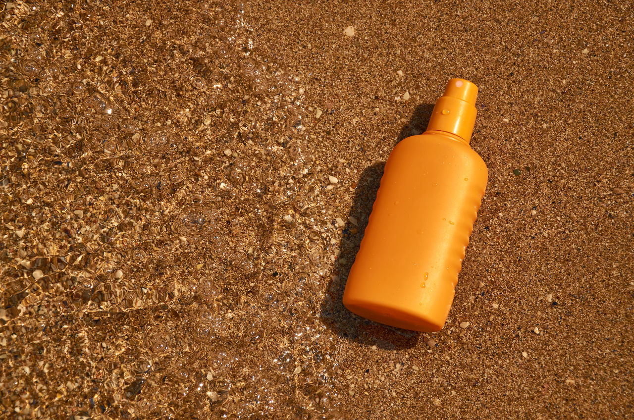yellow, soil, sand, no people, land, bottle, high angle view, beach, single object, brown, orange color, nature, still life
