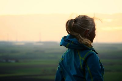 Rear view of woman looking at sunset