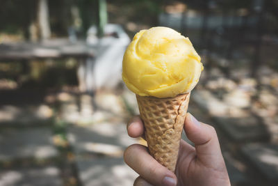 Close-up of hand holding ice cream cone