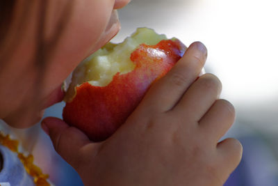 Close-up of girl eating fruit