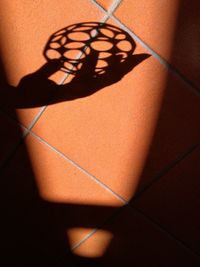 Close-up of shadow on tiled floor