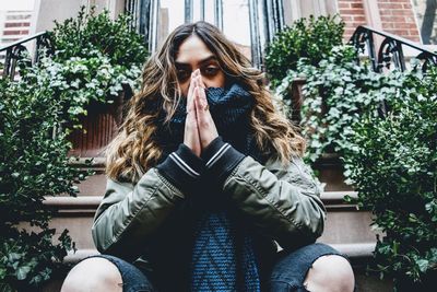 Portrait of young woman sitting outdoors