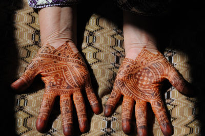 High angle view of woman with henna tattoo
