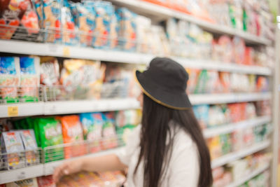 Full length of woman standing at store