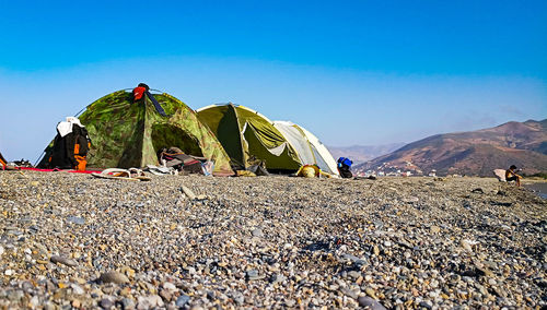 Surface level of tent on mountain against sky