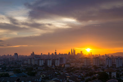 Cityscape against sky during sunset