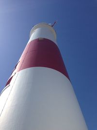 Low angle view of tower against blue sky