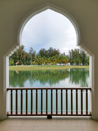 Scenic view of lake seen through window of building