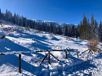 Scenic view of snowcapped mountains against clear blue sky