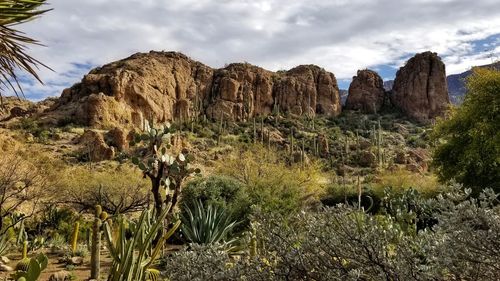 Rock formations on landscape against sky