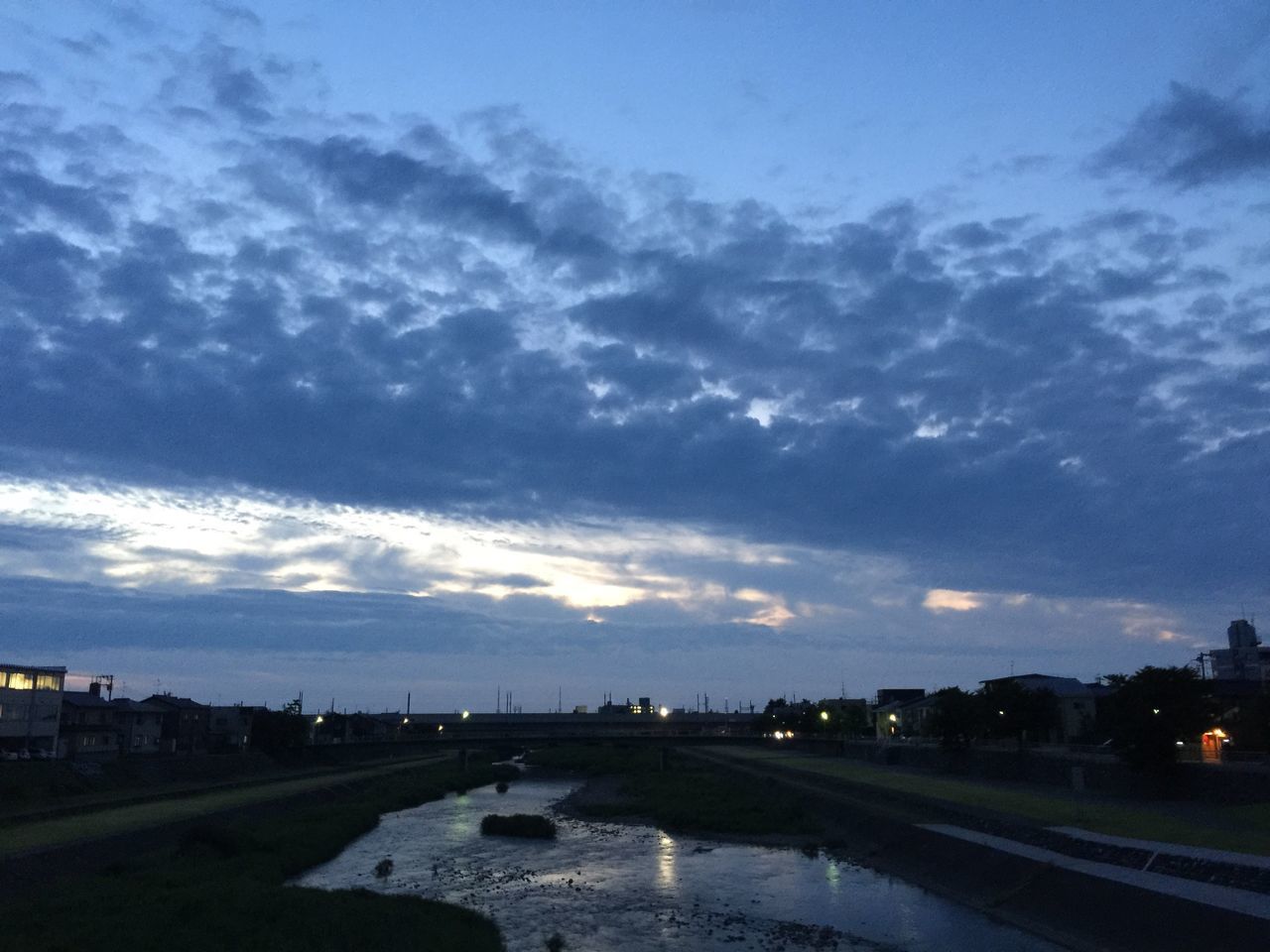 cloud - sky, sky, transportation, no people, built structure, car, architecture, road, outdoors, city, building exterior, nature, day, scenics, tranquility, water, beauty in nature, sunset, cityscape, storm cloud, tree