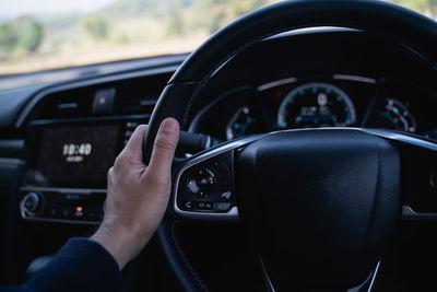 Midsection of man driving car