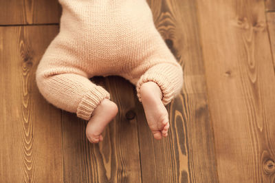 Low section of child on hardwood floor