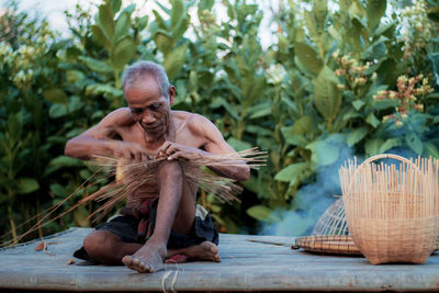 Man sitting on wicker basket