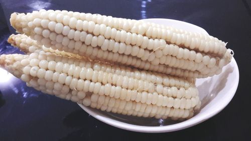 High angle view of white corn in bowl on table