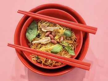 High angle view of food in bowl against red background