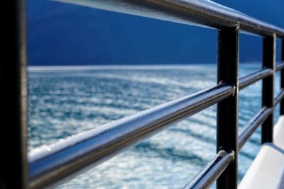 Close-up of boat sailing on sea against sky