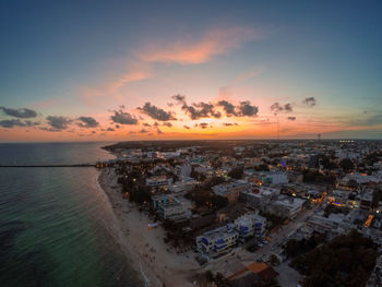 Aerial view of sea against sky during sunset