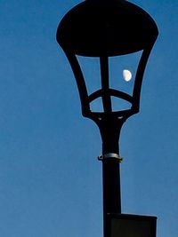 Low angle view of lamp post against clear blue sky