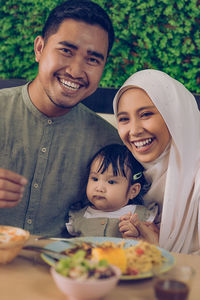 Portrait of happy boy with baby