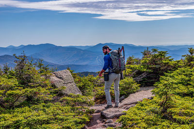 Man standing on mountain against sky