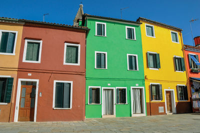 Colorful terraced houses in alley in burano, a little town full of canals near venice, italy.