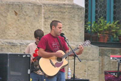 Full length of man playing guitar