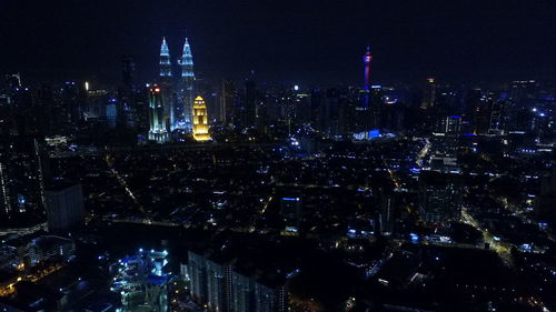 High angle view of city lit up at night