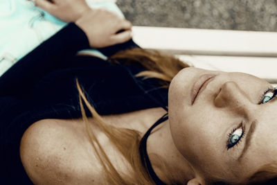 Close-up of woman lying on sofa at home