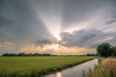 Scenic view of field against sky during sunset