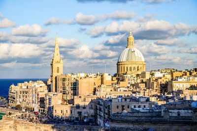 View of buildings in city against sky