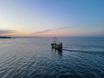 Scenic view of sea against sky during sunset, aerial view of the pirate ship in sopot, poland,
