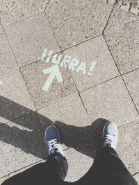 Low section of person standing on road