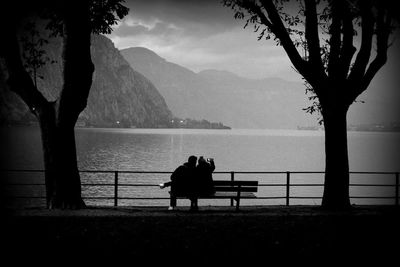 Rear view of silhouette man looking at sea