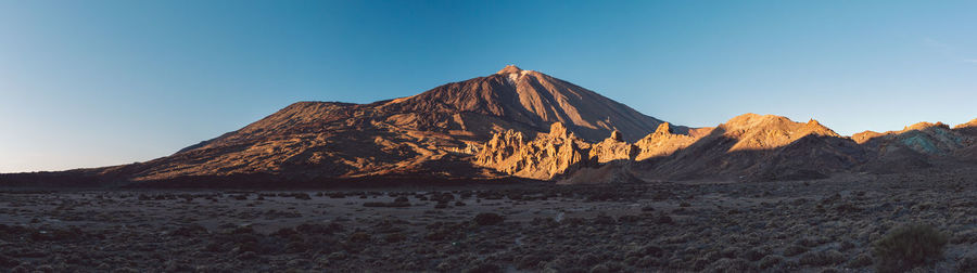 Scenic view of arid landscape against clear sky