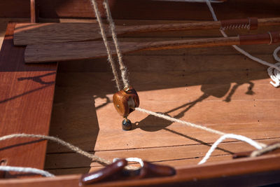 Old wooden sailboat pulleys and ropes detail