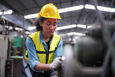 Rear view of engineer working in factory