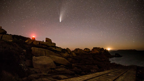 Scenic view of rock against sky at night