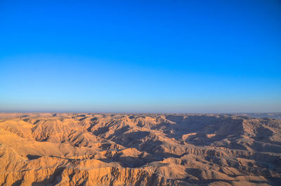 Scenic view of mountains against clear blue sky