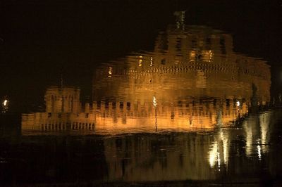 Reflection of illuminated buildings in city at night