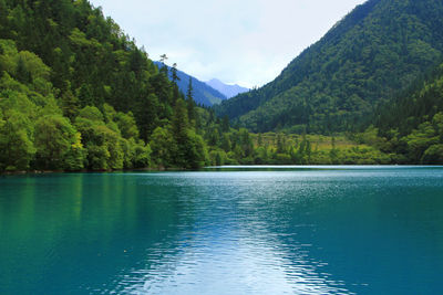 Scenic view of lake and mountains against sky