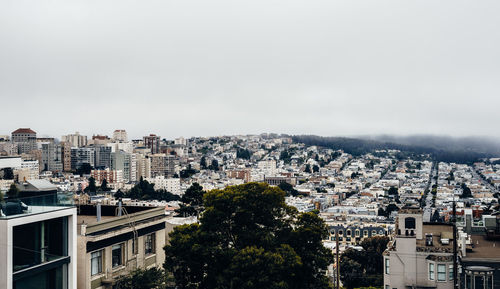 High angle view of buildings in city against clear sky