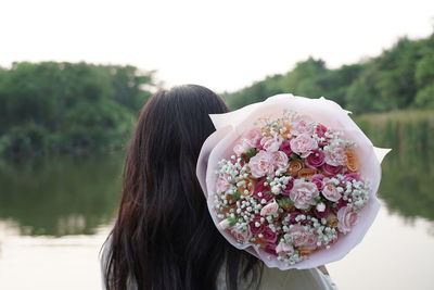 Rear view of woman with bouquet