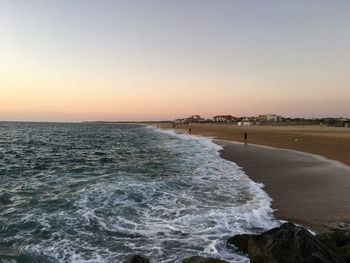 Scenic view of sea against clear sky during sunset