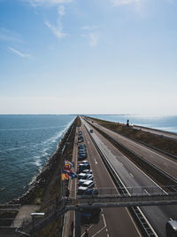 Panoramic view of road by sea against sky