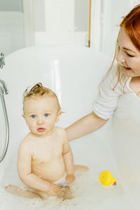 Mother with baby in bath