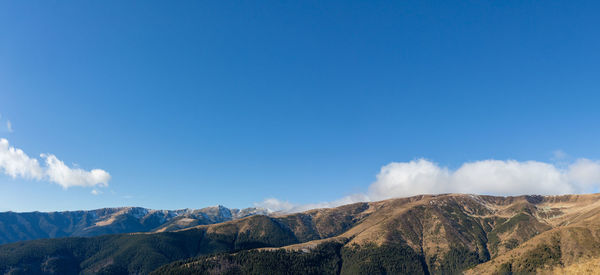 Scenic view of mountains against clear blue sky